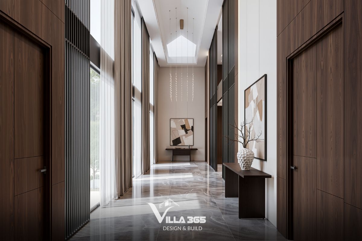 Thiết kế nội thất Breeze Villa – Tối ưu trải nghiệm sống cho gia chủ làm việc tại nhà 6 Bàn console bằng gỗ tối giản đặt sát tường làm bệ đỡ cho bình gốm trắng cắm cành khô và tranh trừu tượng khổ lớn, mang lại nét tĩnh lặng cho hành lang